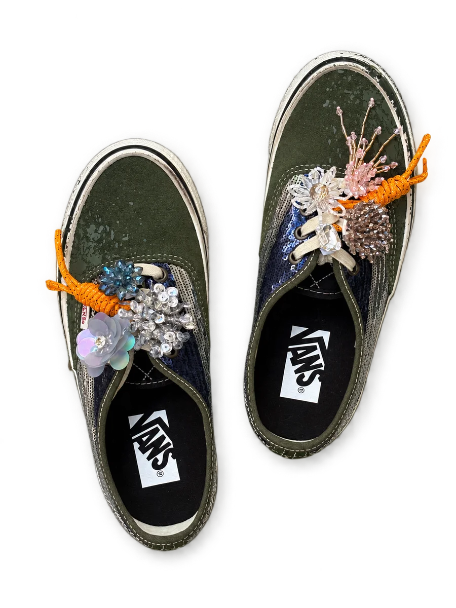 Dark lace-up shoes with flower charms and orange lace accents