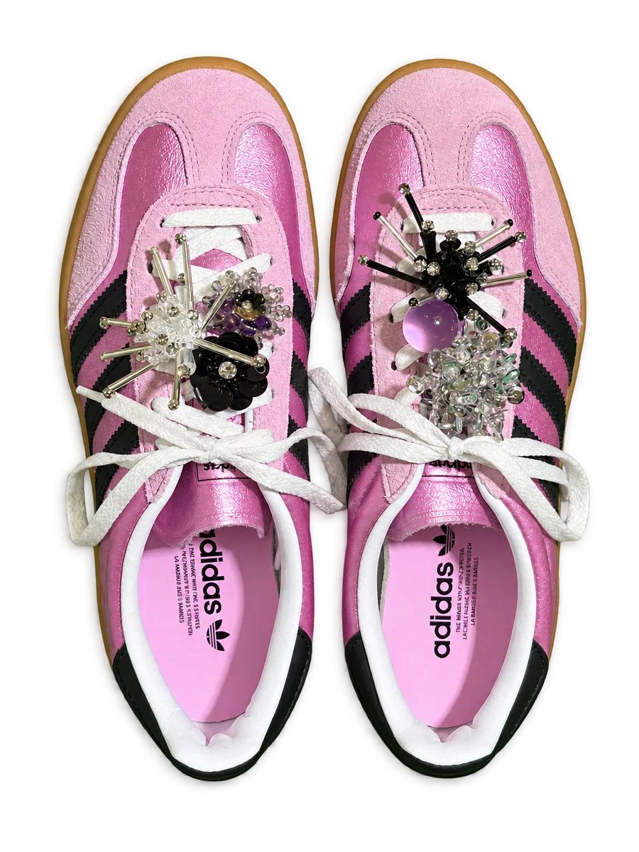 Pink lace-up shoes with silver, purple and black flower charms